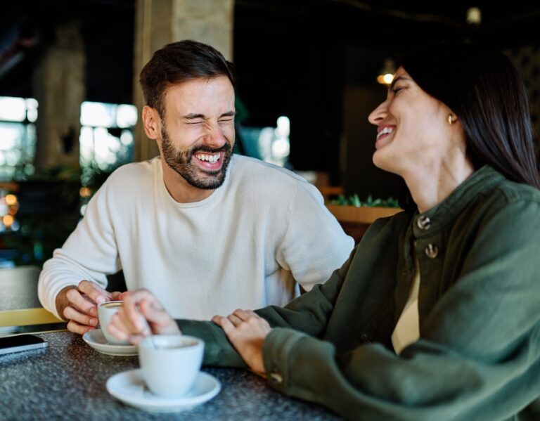 Young,Couple,Enjoying,Conversation,And,Coffee,Together,At,An,Urban